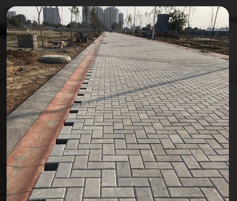 Paved residential driveway and walkway alongside a home, laid by our crew